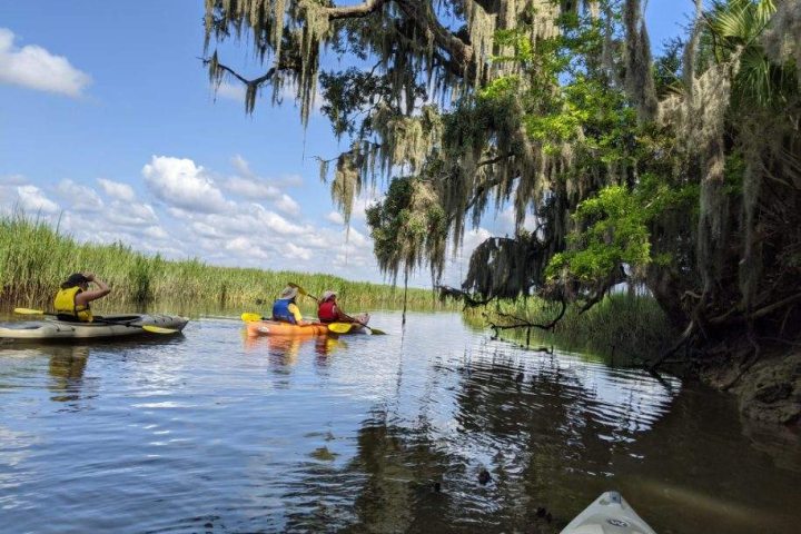 a group of people in a boat on a body of water