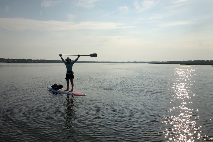 a man standing next to a body of water