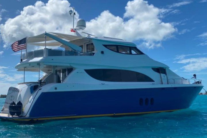 a blue and white boat sitting next to a body of water